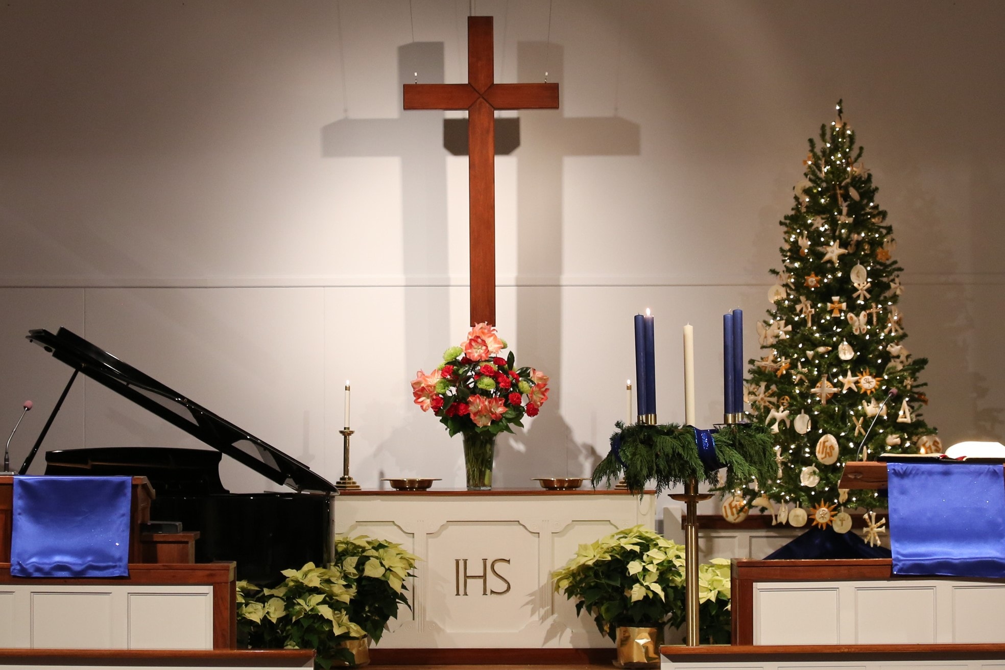 The Glendale United Methodist Church sanctuary in Nashville, Tennessee, is decorated for Advent with symbols of the season, including poinsettias and a Christmas tree.