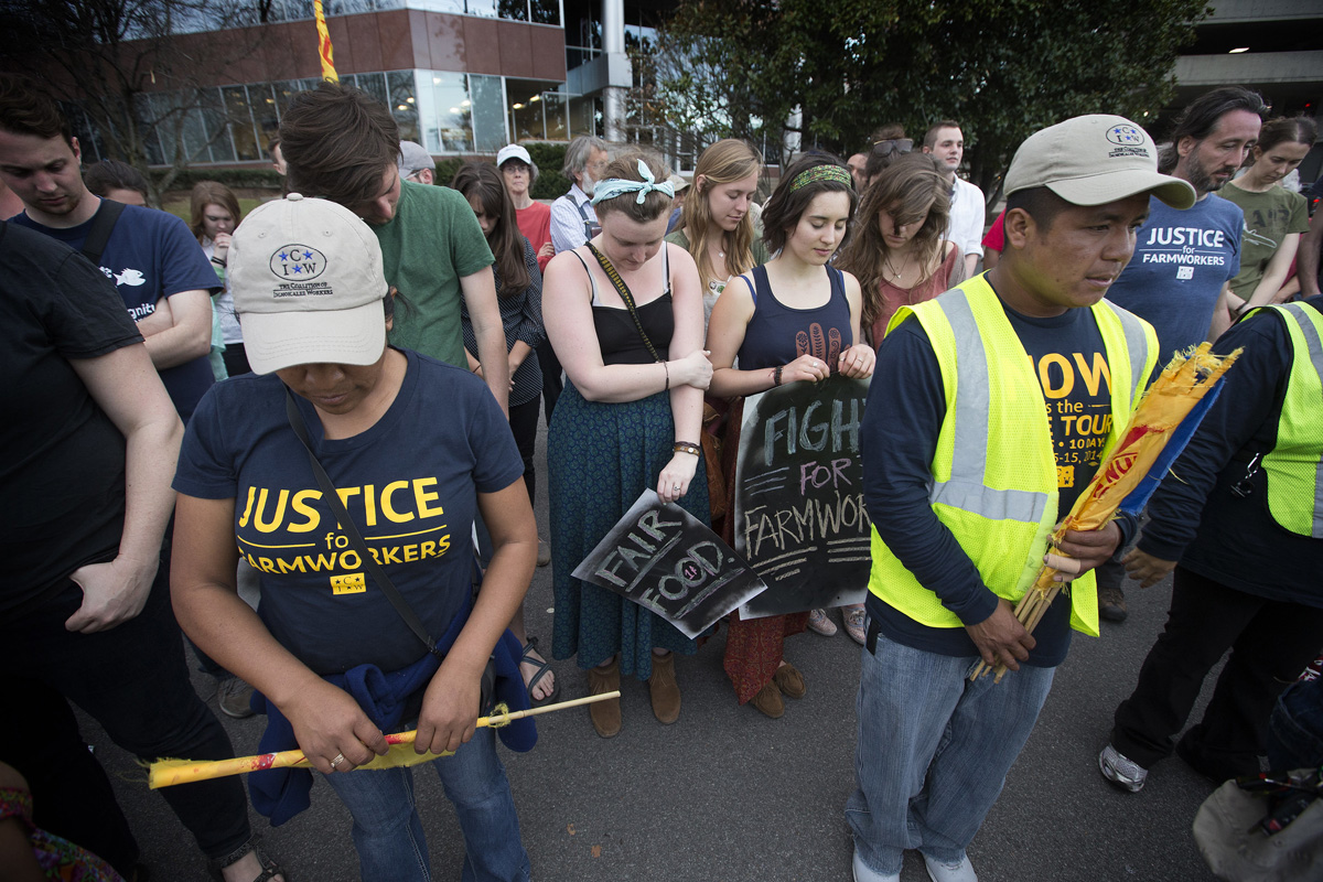 Members and supporters of the Coalition of Immokalee (Fla.) Workers pray in Nashville, Tenn., at the conclusion of a protest against the Publix supermarket chain's refusal to join a farm workers' rights labor program. The Book of Resolutions of the United Methodist Church demands that employers "treat farm workers and their families with dignity and respect.” Photo by Mike DuBose, UM News.