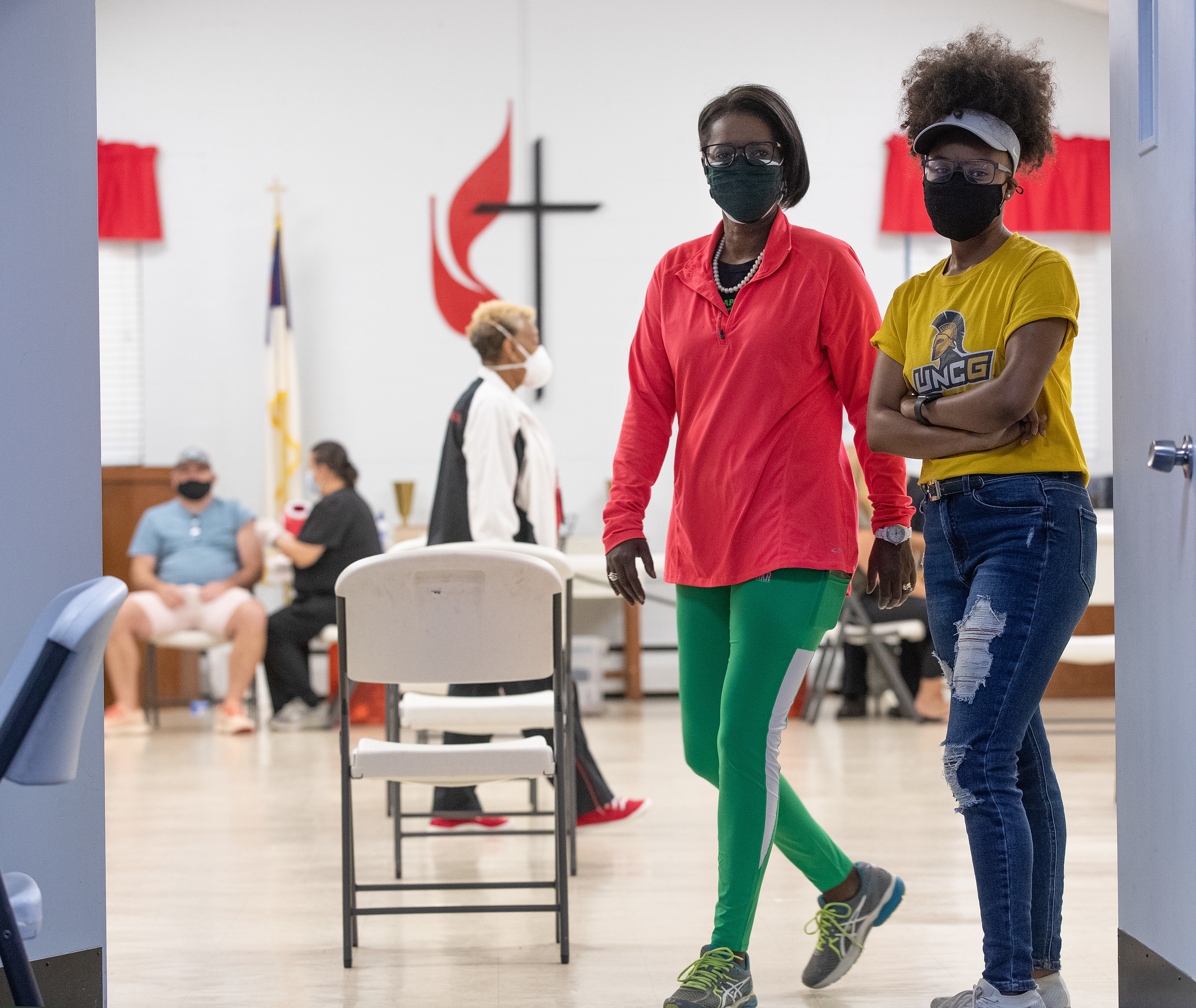 The Rev. Dr. Stephanie Moore Hand (left) and her daughter Ashlee Hand monitor the line of people waiting to receive a COVID-19 vaccination during a clinic at St. Mark’s United Methodist Church in Charlotte, N.C. (Photo by Mike DuBose, UM News.)