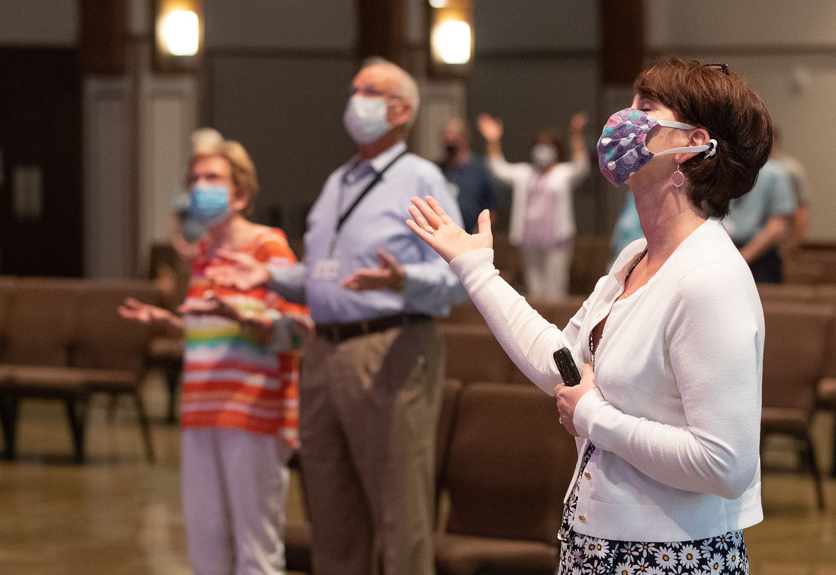 Barbara Layden (front) joins with other parishioners in giving praise during worship at Franklin (Tenn.) First United Methodist Church. The church has adopted safety protocols, including no congregational singing, to help prevent the possible spread of COVID-19. Photo by Mike DuBose, UM News..