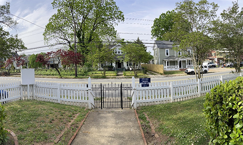 Missionary Julie Wilson tracks the progress of gentrification in her Winston-Salem neighborhood by looking out the front door. The community members Open Arms serves are increasingly losing their rental homes to people who can purchase and rebuild them. The view from the porch of Open Arms Community center in Winston-Salem, NC, shows three recently purchased homes undergoing renovations. Photo: Julie Wilson.