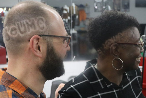 The Rev. Jeff Clinger and Bishop Dee Williamston show off their new cuts. Photo by David Burke.