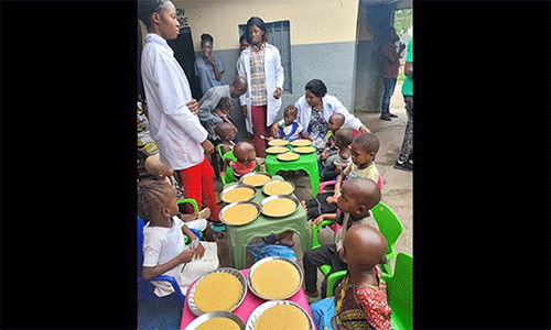 Children receive a porridge meal at Mangobo Methodist Hospital Center in Kisangani, Congo, while staff monitor them. In 2023, The United Methodist Church cared for more than 2,300 malnourished children in the region, include 771 with acute malnutrition. Photo courtesy of the Health Department of The United Methodist Church in Eastern Congo.