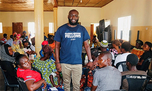 Sam Yav (standing) meets with a group that seeks to understand how climate change impacts their lives and what they can do about it. (Photo: Courtesy of Sam Yav)