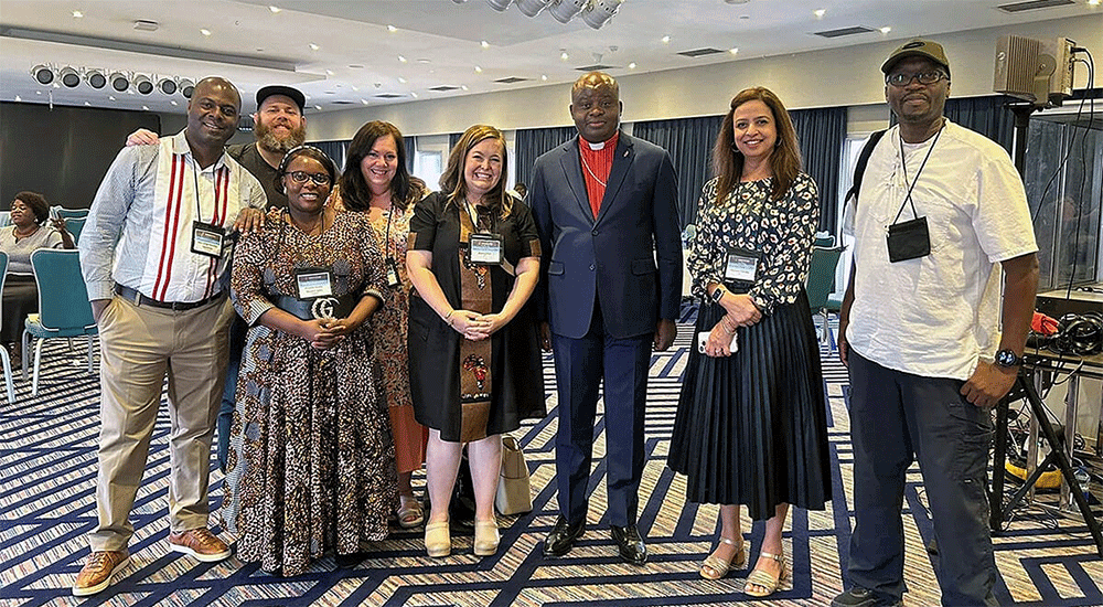 From left, Pacome Nguessan, Matt Crum, Priscilla Muzerengwa, Jennifer Rodia, Ashley Gish, North Katanga Area Bishop Mande Muyombo, Poonam Patodia and Chilima Karima celebrate together at the end of training on regionalization. All but the bishop work for United Methodist Communications. Photo courtesy of United Methodist Communications.