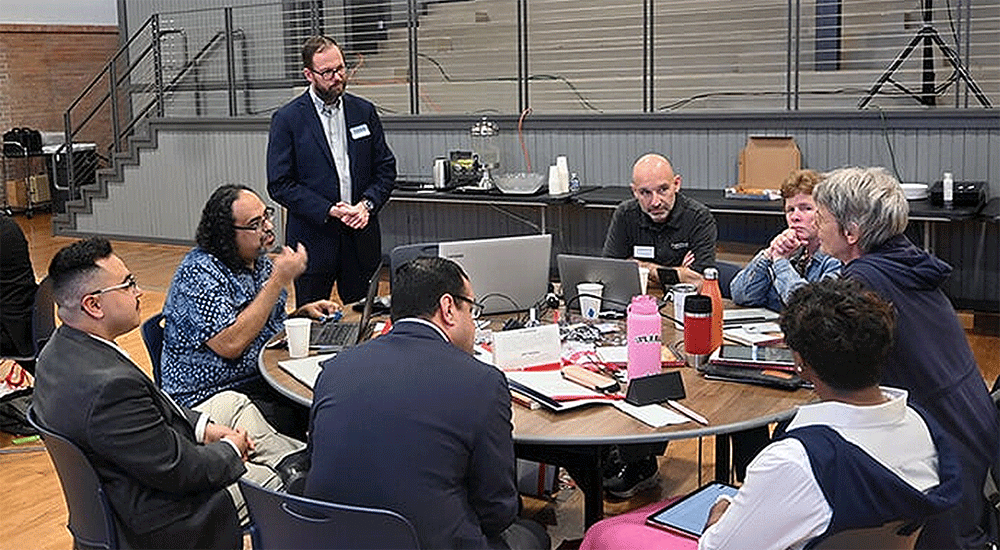 David Scott (standing), senior director of mission theology and strategic planning for the United Methodist Board of Global Ministries, listens to members of the Connectional Table discuss colonialism Oct. 24 during orientation training in Dallas. Photo by Jim Patterson, UM News.