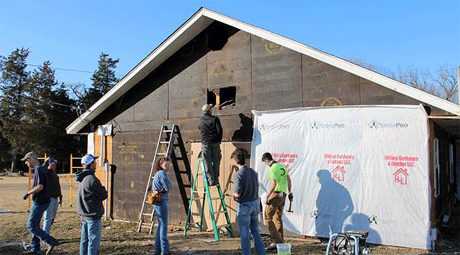  “Yep – there be birds in there.” Kansas State University students get to work on the siding project for Kulli Tuklo UMC in Idabel, Oklahoma. Photo: Courtesy of Oklahoma Indian Missionary Conference