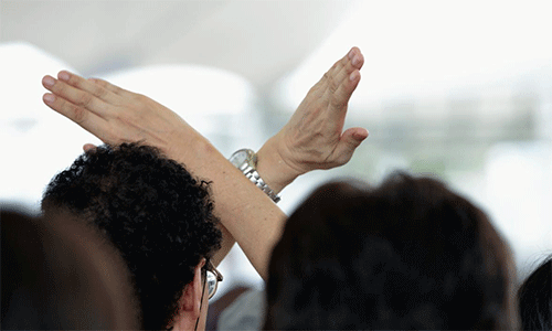 During a memorial ceremony in Nagasaki, Japan, on August 9, 2015, the 70th anniversary of the day the United States dropped an atomic bomb on the city, a man crosses his arms as a sign of protest during a speech by Prime Minister Shinzo Abe, Photo: Paul Jeffrey/Life on Earth Pictures.