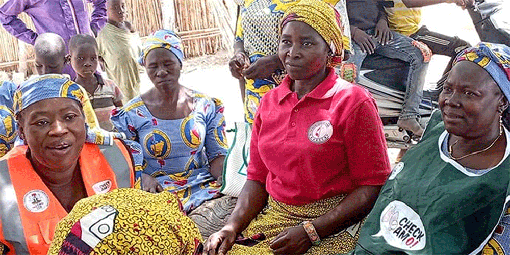 Nurses Jemima Anthiah (left) and Maimuna Eliphaz (right) provide medications and counseling on proper health management to women at Yapilo Village in Gombe State on March 29. The free health services were organized by the Northern Nigeria Conference’s women’s organization. Photo by Ibrahim Babangida, UM News.